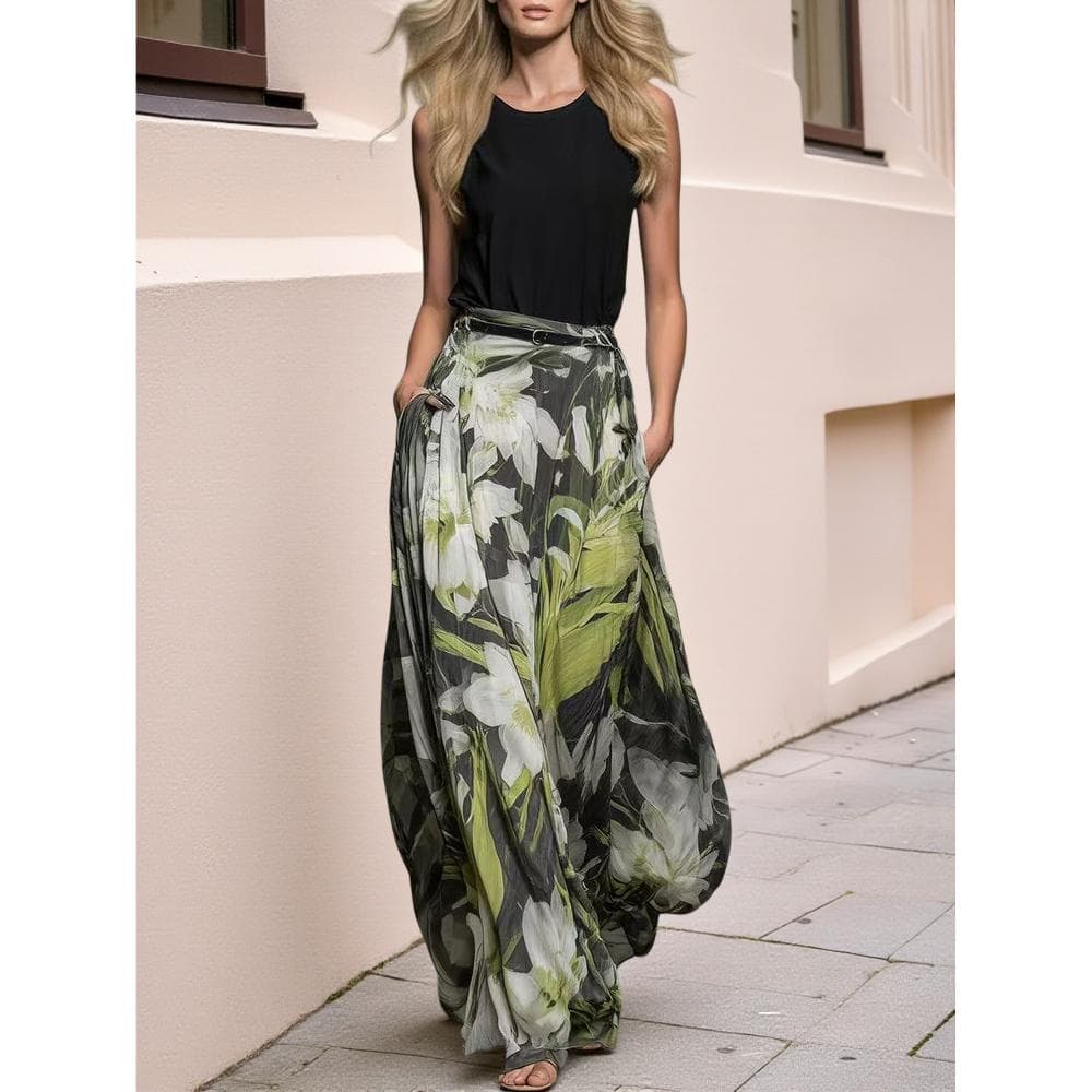 Elegant Women'S Outfit Featuring a Black Sleeveless Crop Top with a Round Neck And a Green Floral Print High-Waisted Flared Maxi Skirt, Ideal for a Gentle Retro Vacation Style, Perfect for Daily Outings And Trips in Spring Or Summer