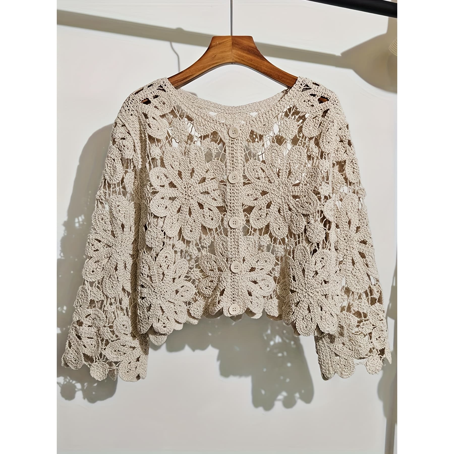 This Artistic Jacquard Cardigan Features Crocheted Openwork That Illustrates a Fanciful Paradise. Detailed Embroidery That Looks Like Vines Surrounds The Hem